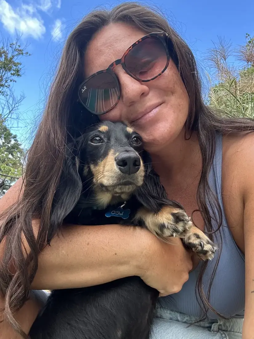 Alana hugging a dachshund