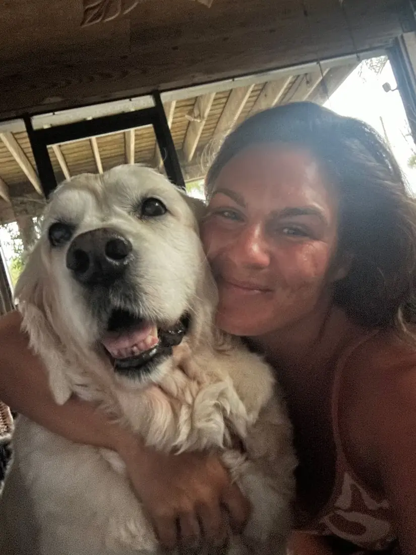 Alana hugging a golden retriever