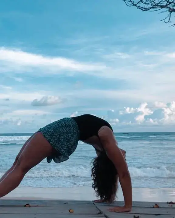 Alana in a yoga backbend on the beach